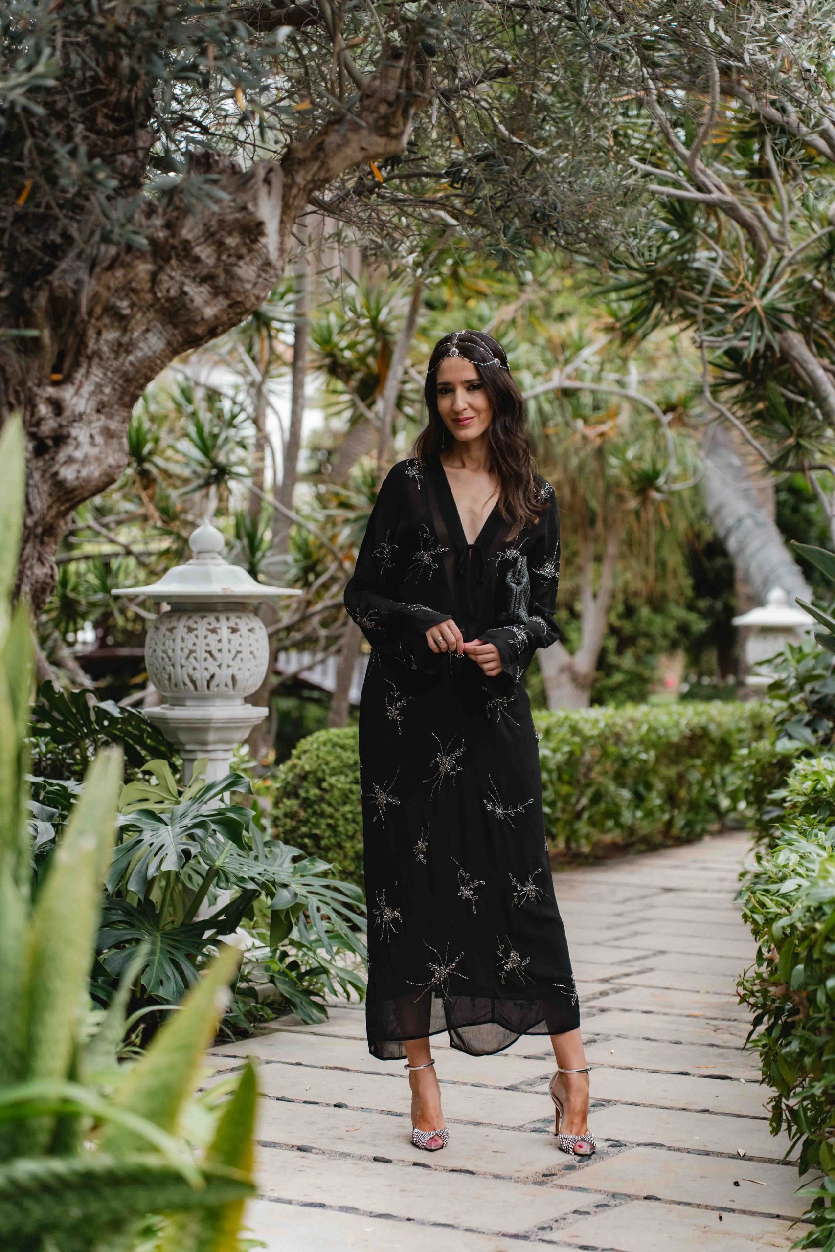 Look invitada de boda boho con vestido negro y casquete