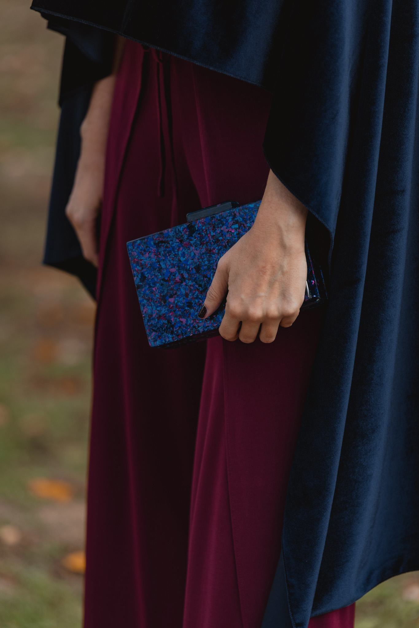 Bolso rígido efecto nácar morado y azul de Masario en estilismo de invierno