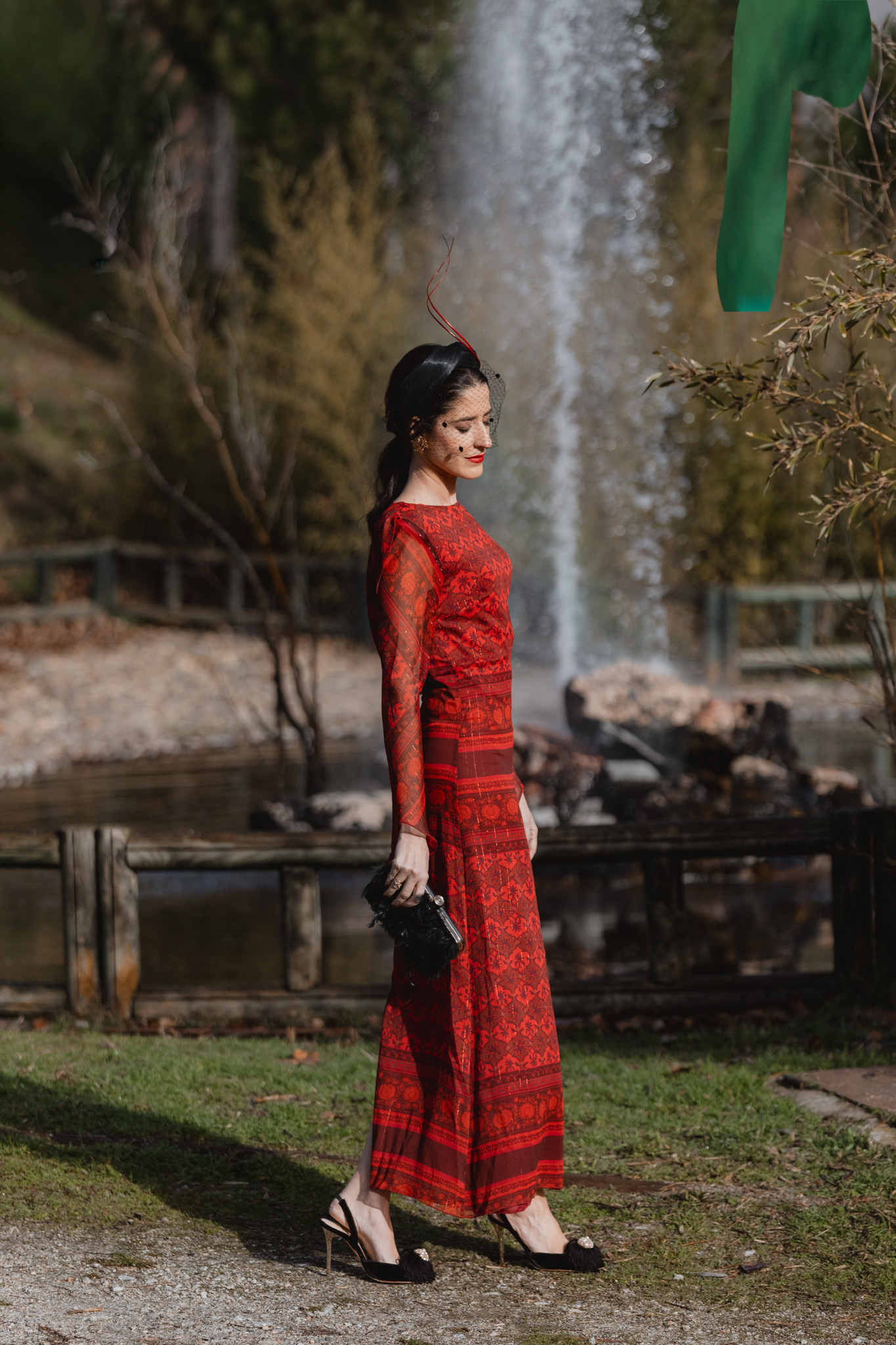 Look de invitada de invierno con vestido rojo y tocado de diadema